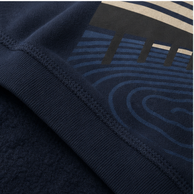 Close-up of Navy sponge fleece, ribbing and matte Ocean Study print