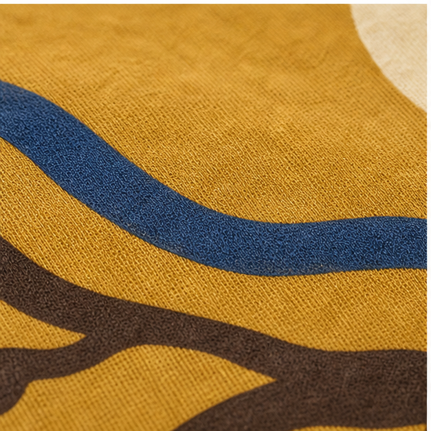 Close-up of Mustard cotton and matte Root and Rhythm print